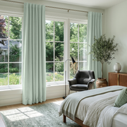Mint Green Velvet Back Tab Curtains in a Bright Bedroom with White Walls and Grey Bedding