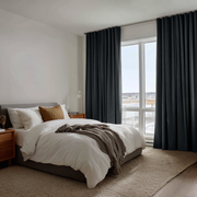 Steel Black Velvet Back Tab Curtains in a Contemporary Bedroom with Neutral Bedding and Warm Wood Accents