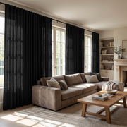 Black Back Tab Extra Long Curtains in a Transitional Living Room with Neutral Sofa and Built-In Shelving