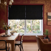Black Roman Blinds in a Dining Room with Textured Red Walls and Wooden Dining Table