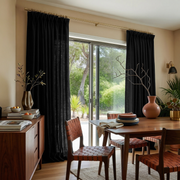 Black Linen Pinch Pleat Curtains for Bifold Doors in a Dining Room with Cream Walls
