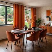Burnt Orange Linen Eyelets Curtains in a Contemporary Dining Room with Light Grey Plaster Walls and a Black Marble Oval Table Surrounded by Velvet Chairs - Cotton Lining 