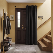 Charcoal Grey Thermal Door Curtain in a Hallway with Warm Beige Walls and Wooden Stairs