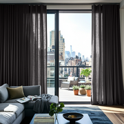 Charcoal Grey Linen S-Fold Curtains for Bifold Doors in a Living Room with Warm White Walls