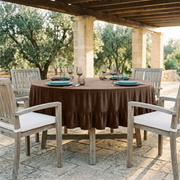 Chocolate Brown Velvet Round Ruffle Tablecloth in an Outdoor Patio Dining Space with Stone Flooring and Weathered Wood