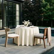 Cream Linen Round Tablecloth in an Outdoor Poolside Dining Setting