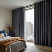 Dim Grey Linen Eyelet Curtains in a Bright City Bedroom With Warm Beige Walls - Blackout Lining
