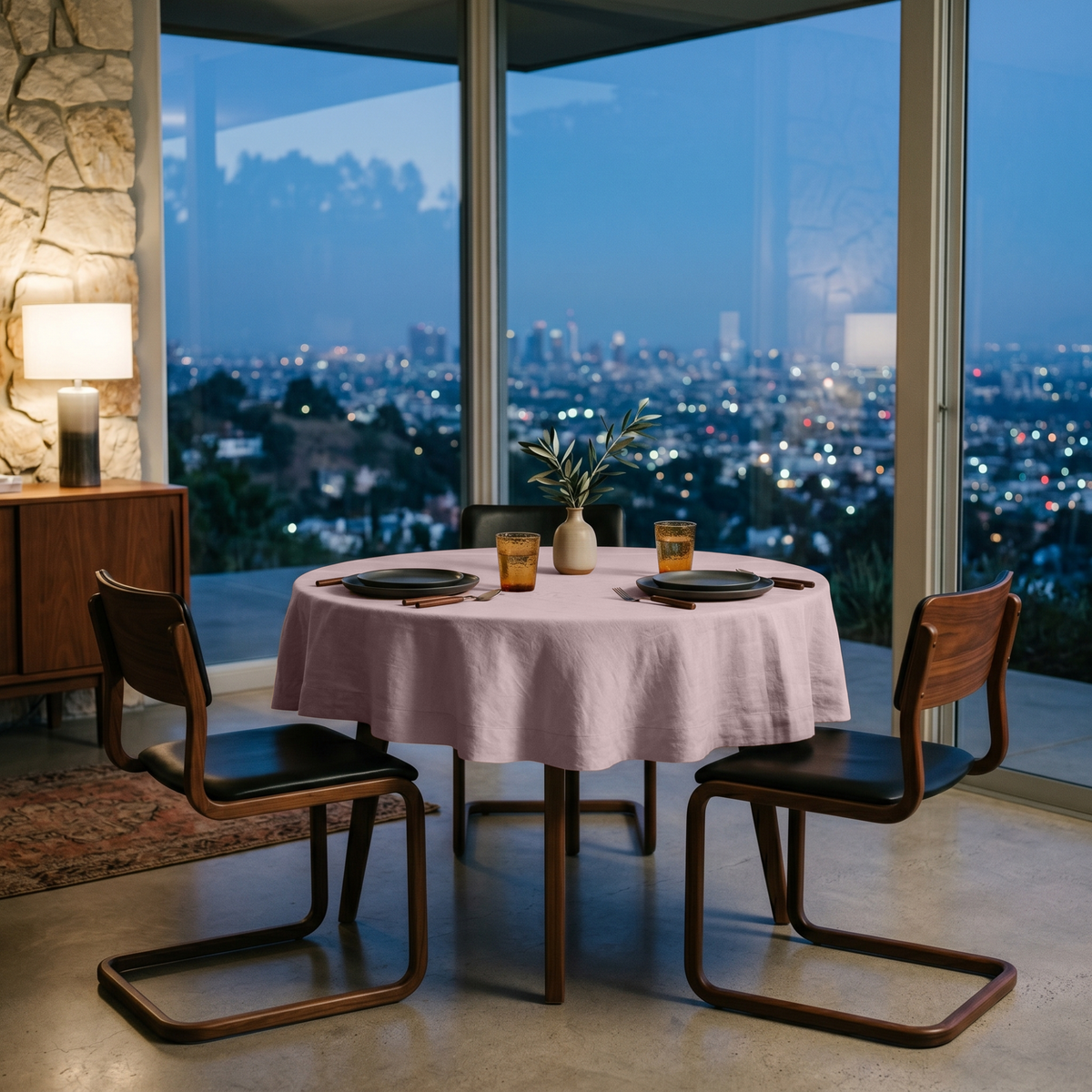 Dusty Pink Linen Small Round Tablecloth in a City View Dining Space with Stone Walls and Walnut Wood