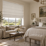 Heavy Ecru Roman Blinds in an English Country Bedroom with Warm Cream Walls and a Light Wood Coffee Table