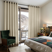 Ecru Heavy Weight Linen Eyelet Curtains in a Mountain Bedroom With a Green Velvet Chair and Balcony Doors - Blackout Lining