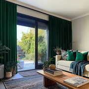 Emerald Green Velvet Pencil Pleat Blackout Curtains for Bifold Doors in a Living Room with Light Grey Walls