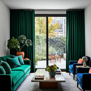 Emerald Green Velvet S-Fold Blackout Curtains for Sliding Doors in a Living Room with Light Grey Walls