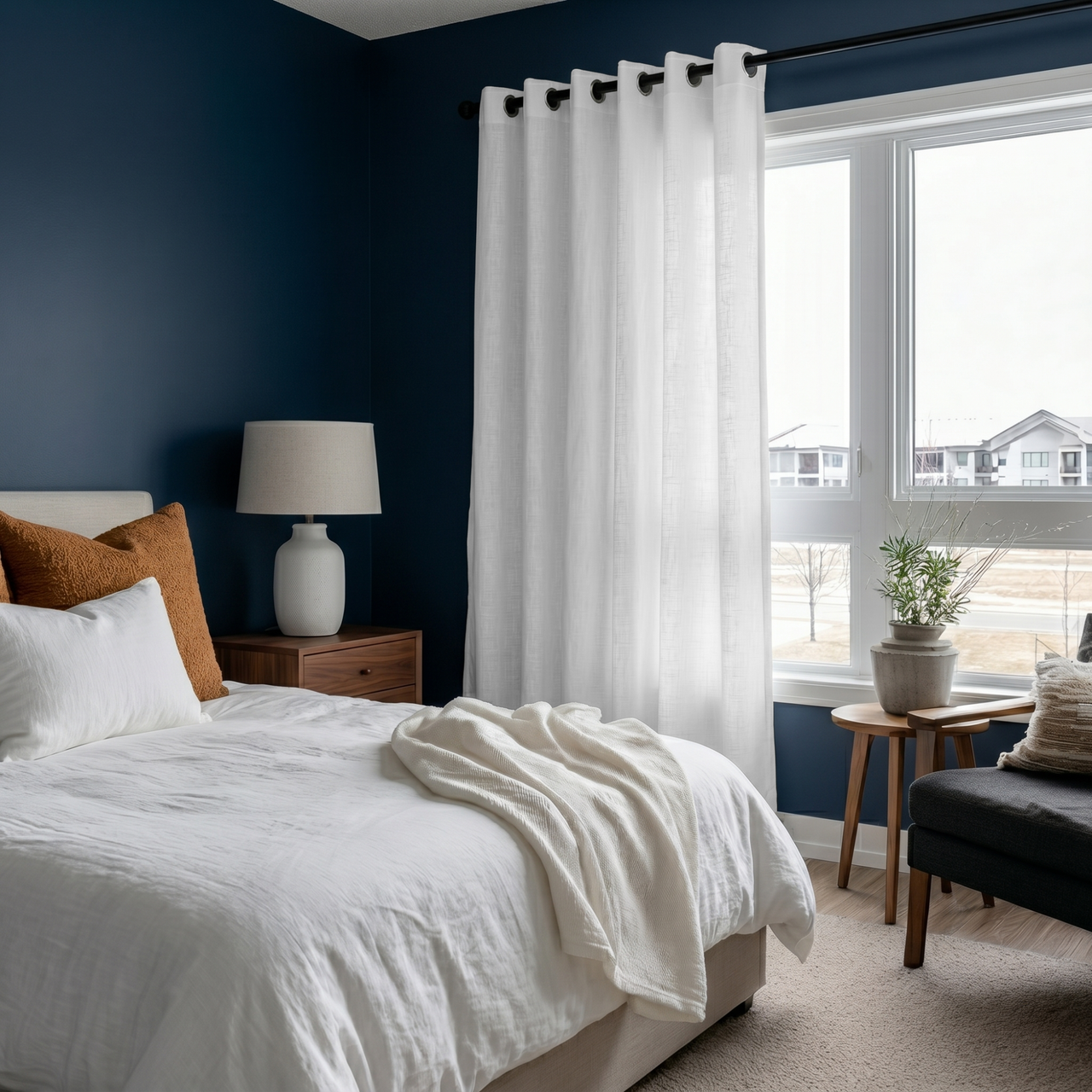 White Linen Eyelet Curtains in a Cozy Blue Bedroom With White Bedding and a Large Window