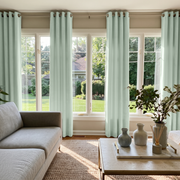 Mint Green Velvet Eyelet Curtains in a Bright Living Room with a Gray Sectional Sofa and Marble Coffee Table