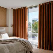 Terracotta Heavy Weight Linen Eyelet Curtains in a Bright Neutral Bedroom With Warm White Walls - Blackout Lining