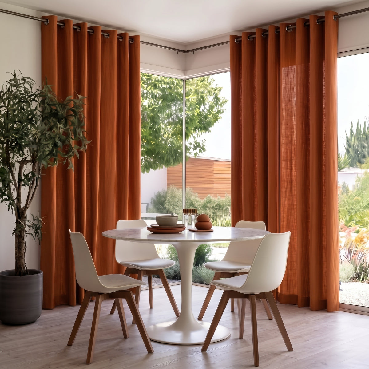 Heavy Weight Terracotta Linen Eyelets Dining Room Curtain in a Modern Dining Room with White Walls and a White Marble Table Surrounded By White Shell Chairs.