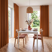 Heavy Weight Terracotta Linen S-fold Dining Room Curtain in a Contemporary Dining Room with White Walls and a Woven Pendant Light Suspended Over Light Wood Dining Chairs - Blackout Lining