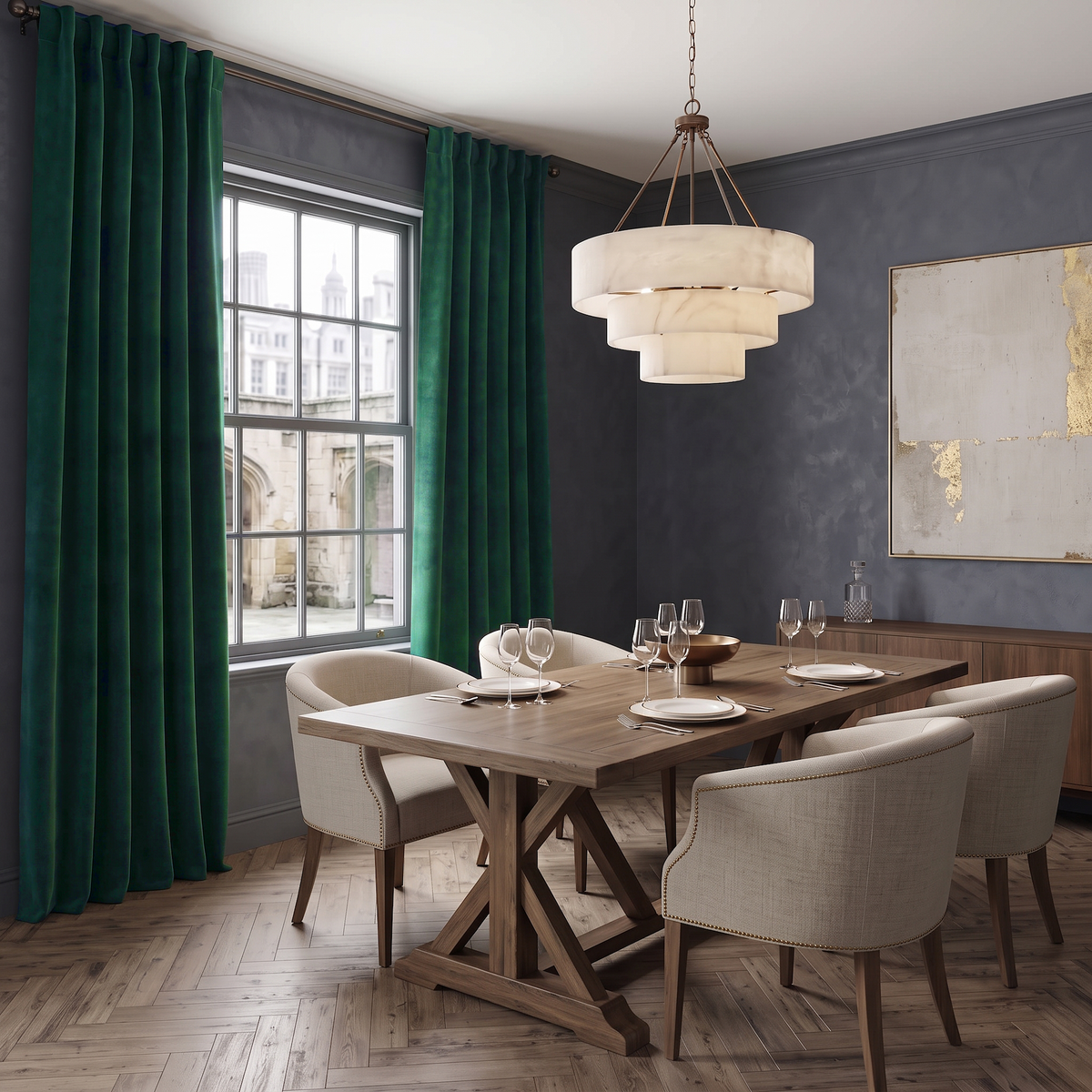A styled dining room featuring a wooden trestle table with six upholstered chairs, a tiered cream pendant light, deep green velvet curtains, and dark gray textured walls.