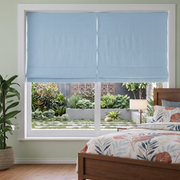 Sky Blue Cordless Linen Roman Blinds in a Modern Bedroom with Soft Green Walls and a Wooden Bed Frame