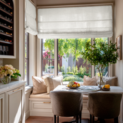 Off-White Linen Kitchen Roman Blinds in a Cozy Breakfast Nook Kitchen with a Soft Neutral Cabinetry - Blackout Lining