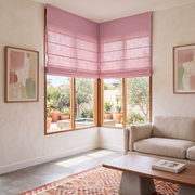 Dusty Rose Roman Blinds in a Modern Living Room with Cream Walls and a Geometric Pattern Rug