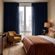 Royal Blue Linen Pencil Pleat Curtains in a Warm Beige Bedroom with Mid-Century Wood Furniture