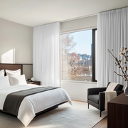 White Linen Pencil Pleat Bedroom Curtains in a Minimal Bedroom with Soft Greige Walls and Black Accents