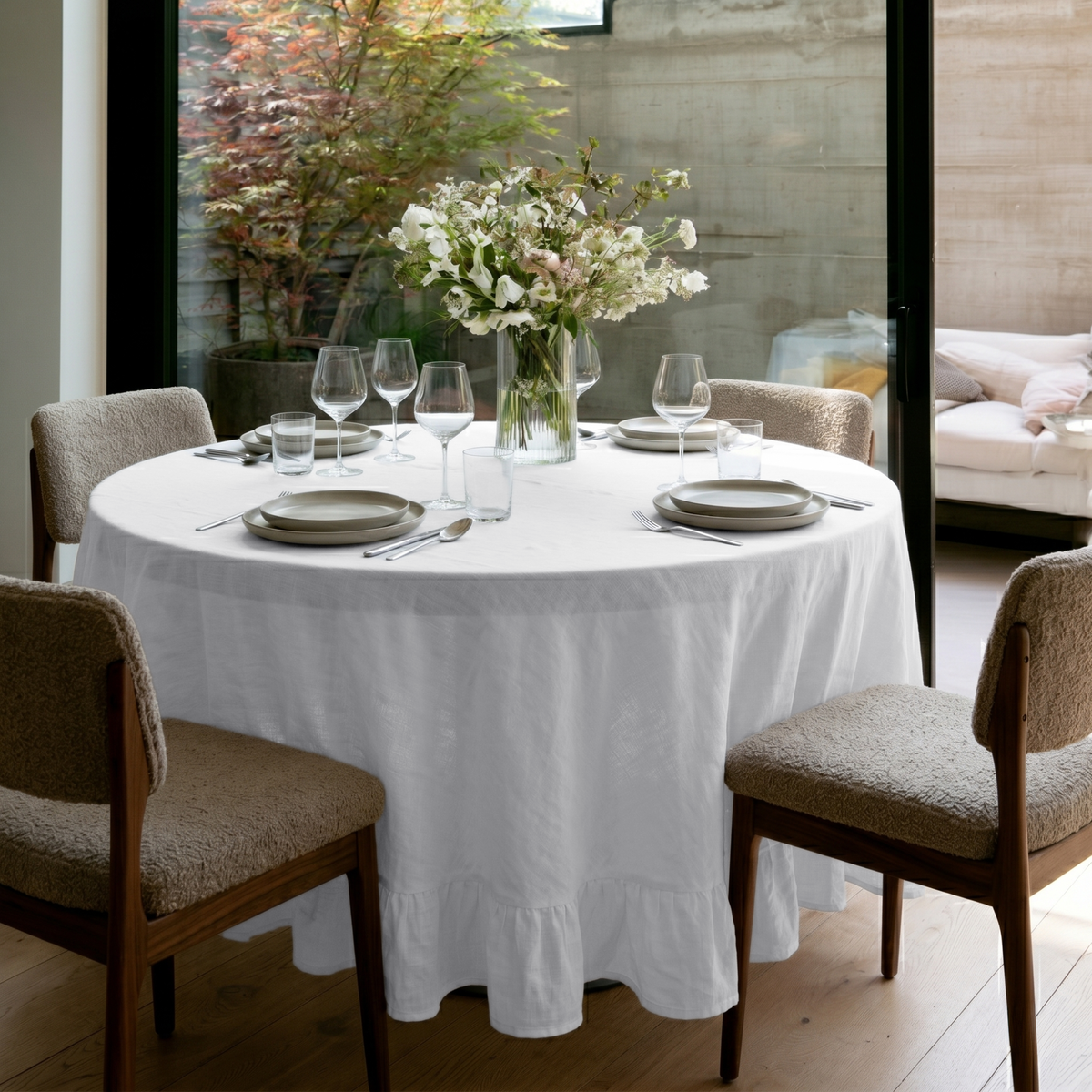 White Linen Round Ruffle Tablecloth in a Modern Dining Room with Bouclé Upholstery