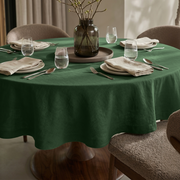 Forest Green Linen Round Tablecloth in a Soft Neutral Dining Room with Light Greige Walls and Taupe Upholstery