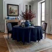 Royal Blue Linen Round Tablecloth in an Elegant Dining Room with White Wall Paneling and Blue Ceramic