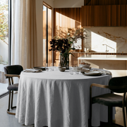 Stone Grey Linen Round Tablecloth in a Modern Kitchen Dining Space with Wood Slat Cabinetry