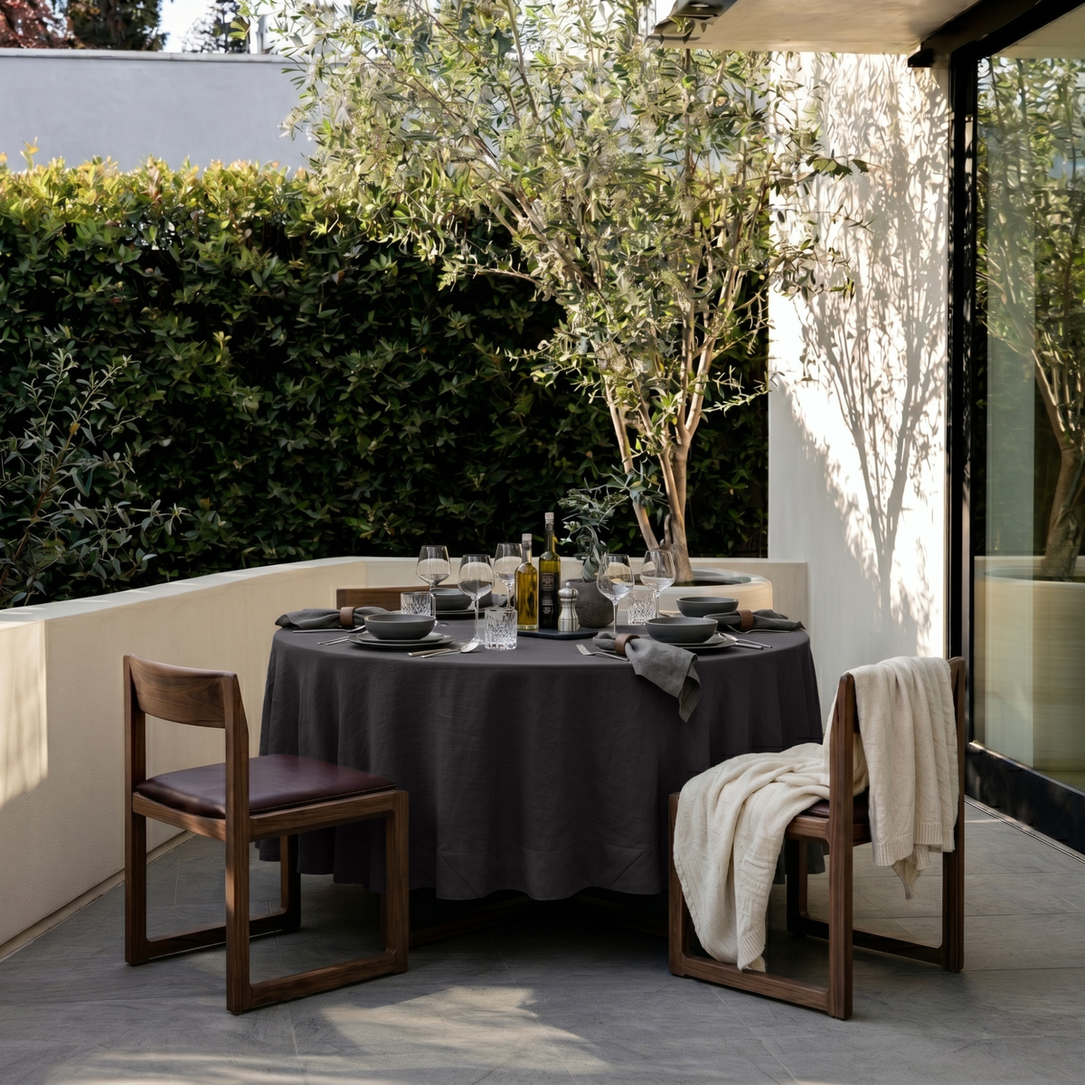 Charcoal Grey Linen Round Tablecloth in an Outdoor Patio Dining Setting