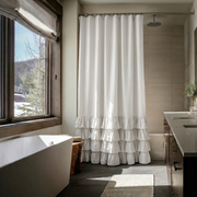 Off-White Linen Ruffle Shower Curtain in a Rustic Modern Bathroom with Soft Ivory Accents