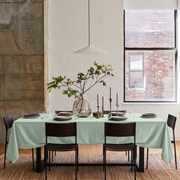 Mint Green Rectangular Velvet Tablecloth in an Industrial Dining Room with White Brick Walls and Dark Brown Leather Chairs