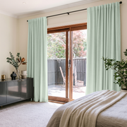 Mint Green Velvet Back Tab Sliding Patio Door Curtains in a Modern Bedroom with White Bedding and a Black Sideboard