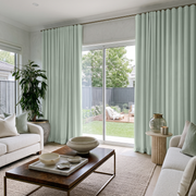 Mint Green Velvet S-Fold Curtains in a Bright Living Room with White Bouclé Sofas and a Walnut Coffee Table