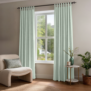 Mint Green Velvet Tab Top Curtains in a Minimal Sitting Room with Taupe Walls and a Cream Bouclé Chair