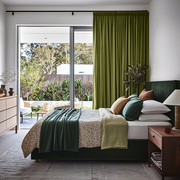 Moss Green Linen Pencil Pleat Curtains for Bifold Doors in a Bedroom with White Walls