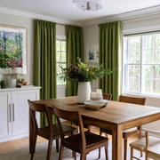 Moss Green Linen Rod Pocket Curtains in a Transitional Dining Room with Wooden Table and Botanical Artwork