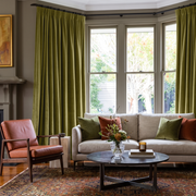 Moss Green Velvet Pencil Pleat Curtains in a Traditional Living Room with Taupe Walls and a Rust Leather Chair