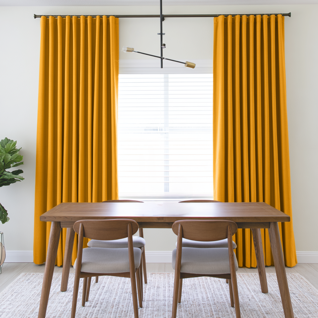 Mustard Yellow Linen S-Fold Curtains in a Contemporary Dining Room with Light Wood Furniture and Minimalist Pendant Light