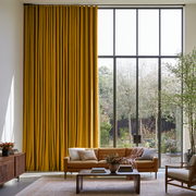 Mustard Yellow Linen S-Fold Extra Long Curtains in a Contemporary Living Room with a Large Black-Framed Window and an Orange Sofa