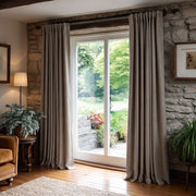 Natural Heavy Weight Linen Back Tab Extra Long Curtains in a Rustic Contemporary Living Room with Stone Walls and Garden Views