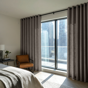 Natural Heavy Weight Linen Eyelet Bedroom Curtains in a Minimal Bedroom with Warm Neutral Walls and Leather Chair - Cotton Lining