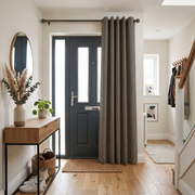 Natural Heavy Weight Thermal Door Curtains in a Hallway with Off-White Walls and a Wooden Console Table