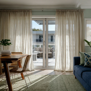 Natural Voile Linen Pencil Pleat Curtains for Sliding Doors in a Living Room with Sage Green Walls