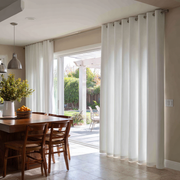 Off-White Heavy Weight Linen Eyelet Curtains for Bifold Doors in a Dining Room with Beige Walls - Cotton Lining