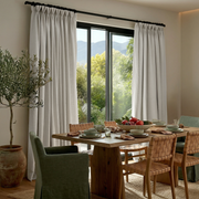 Off-White Heavy Weight Linen Pinch Pleat Curtains for Bifold Doors in a Dining Room with Beige Walls