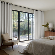 Off-White Linen Eyelet Bedroom Curtains in a Warm Bedroom with Greige Walls and Honey Wood Furniture