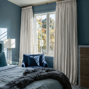 Off-White Linen Pencil Pleat Curtains in a Sophisticated Blue Accent Bedroom with Plush Fabrics - Blackout Lining